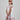 Girl in floral and flamingo print dress with scalloped cape and gathered skirt.