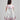 Girl in floral and flamingo print dress with scalloped cape and gathered skirt.