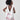 Girl in taffeta A-line dress with flamingo print, tulle sleeves, and back bow.