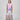 Girl in tiered Dubai-print maxi dress with lace panels and open-back tie.