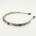 Decorative headband with gemstones on a white background
