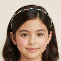 Young girl wearing a decorative headband with gemstones on a beige background
