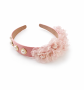 Pink headband with floral design and gold accents on a white background