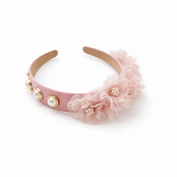 Pink headband with floral decorations and pearl embellishments on a white background