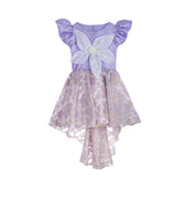Lilac high-low occasion dress with petal-shaped white flower and floral brocade skirt – Bloomlight Dress for girls aged 5–14.
