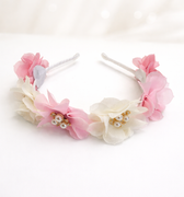 Floral headbands with pink and white flowers on a white background