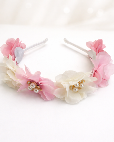 Floral headbands with pink and white flowers on a white background