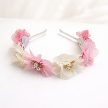 Floral headbands with pink and white flowers on a white background