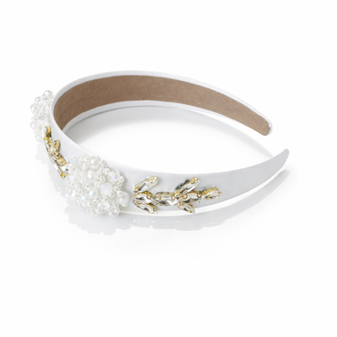 Decorative headband with pearls and gold accents on a white background