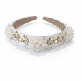 White headband with gold accents and floral decorations on a white background