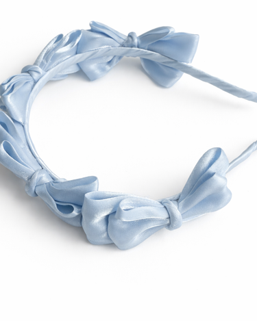 Blue satin knot headband for girls with sculpted knot detailing