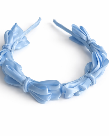 Blue satin knot headband for girls with sculpted knot detailing