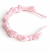 Pink satin knot headband for girls with sculpted knot detailing
