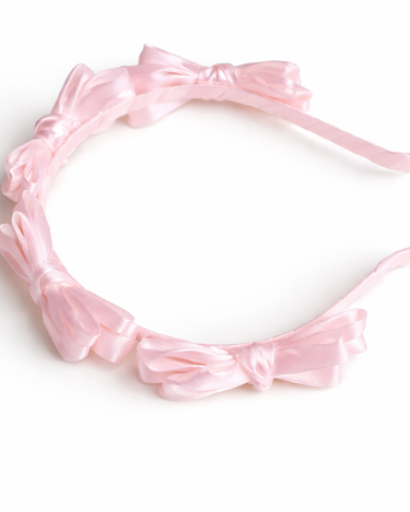 Pink satin knot headband for girls with sculpted knot detailing
