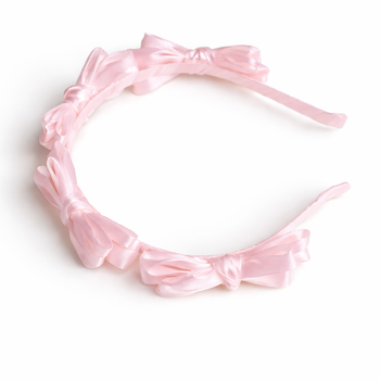 Pink satin knot headband for girls with sculpted knot detailing
