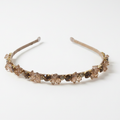 Decorative headband with brown gemstones on a white background