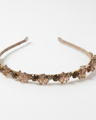 Decorative headband with brown gemstones on a white background