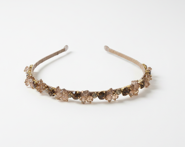 Decorative headband with brown gemstones on a white background