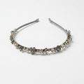 Silver headband with decorative elements on a white background