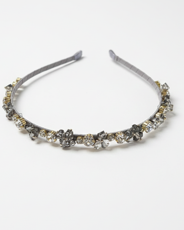 Silver headband with decorative elements on a white background