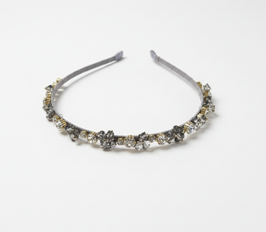 Silver headband with decorative elements on a white background
