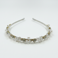 Silver headband with clear crystals on a white background