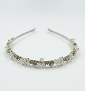 Silver headband with clear crystals on a white background