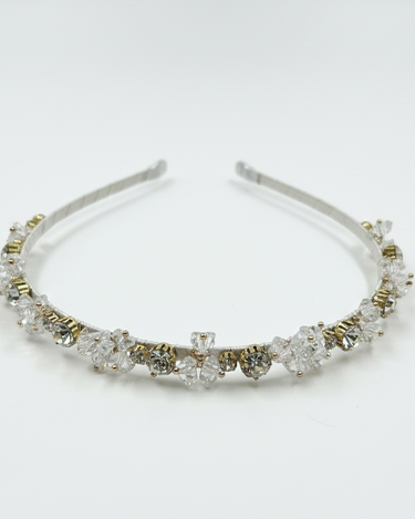 Silver headband with clear crystals on a white background
