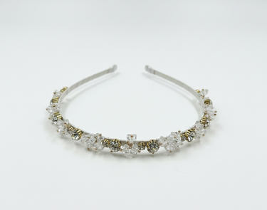 Silver headband with clear crystals on a white background