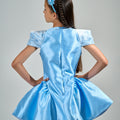 Girl in royal blue taffeta dress with sequin lace front and velvet bow accents.