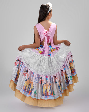 Girl in tiered Dubai-print maxi dress with lace panels and open-back tie.