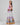 Girl in tiered Dubai-print maxi dress with lace panels and open-back tie.