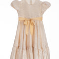 Champagne gold high-low dress for girls with puff sleeves, satin sash, and soft shimmer, perfect for weddings, Eid, and special occasions.