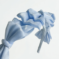 Blue satin knot headband for girls with sculpted knot detailing