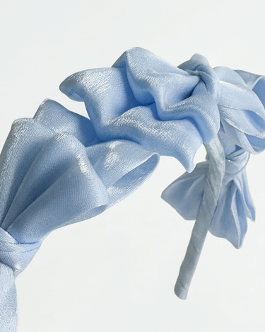 Blue satin knot headband for girls with sculpted knot detailing