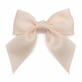 Large pink hair bow on a white background