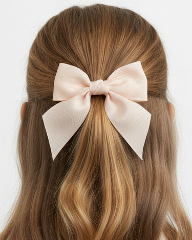 Long brown hair with a large pink bow on a white background