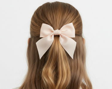 Long brown hair with a large pink bow on a white background