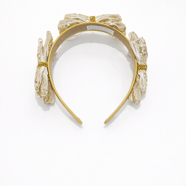 Gold headband with floral designs on a white background
