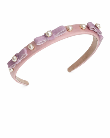 Pink headband with bows and pearls on a white background