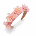 Pink floral headband on a white background