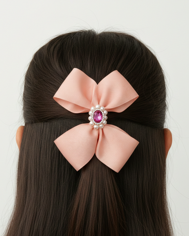 Pink hair bow with a decorative center on a mannequin head against a white background