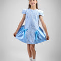 Girl in royal blue taffeta dress with sequin lace front and velvet bow accents.
