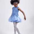 Girl in azure sequin lace dress with dramatic flared tulle hem.
