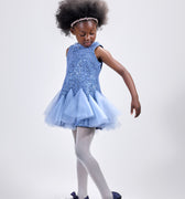 Girl in azure sequin lace dress with dramatic flared tulle hem.