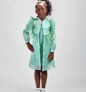 Girl in mint glitter jersey dress with silk organza overshirt and feather trim.