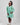 Girl in mint glitter jersey dress with silk organza overshirt and feather trim.