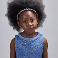Girl in sequined lace and denim-look taffeta dress with flutter sleeves.