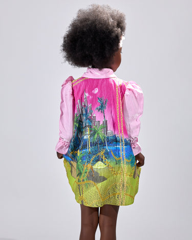 Girl in pink top and Dubai desert print skirt with front buttons.