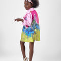 Girl in pink top and Dubai desert print skirt with front buttons.
